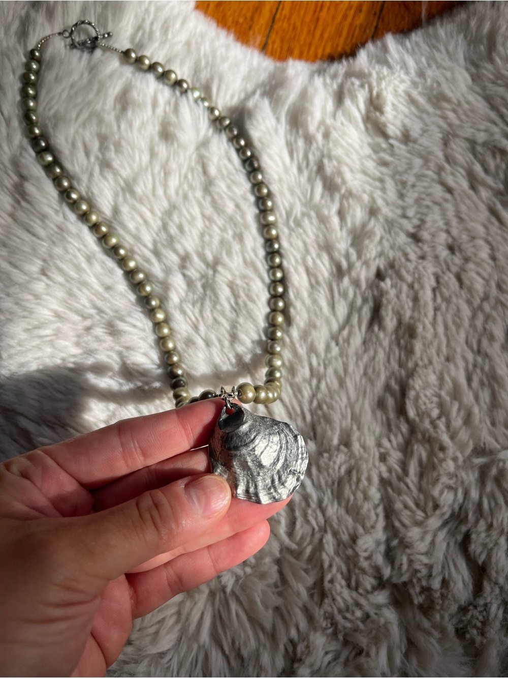Gorgeous cast-Metal shell necklace on a green faux pearl strand